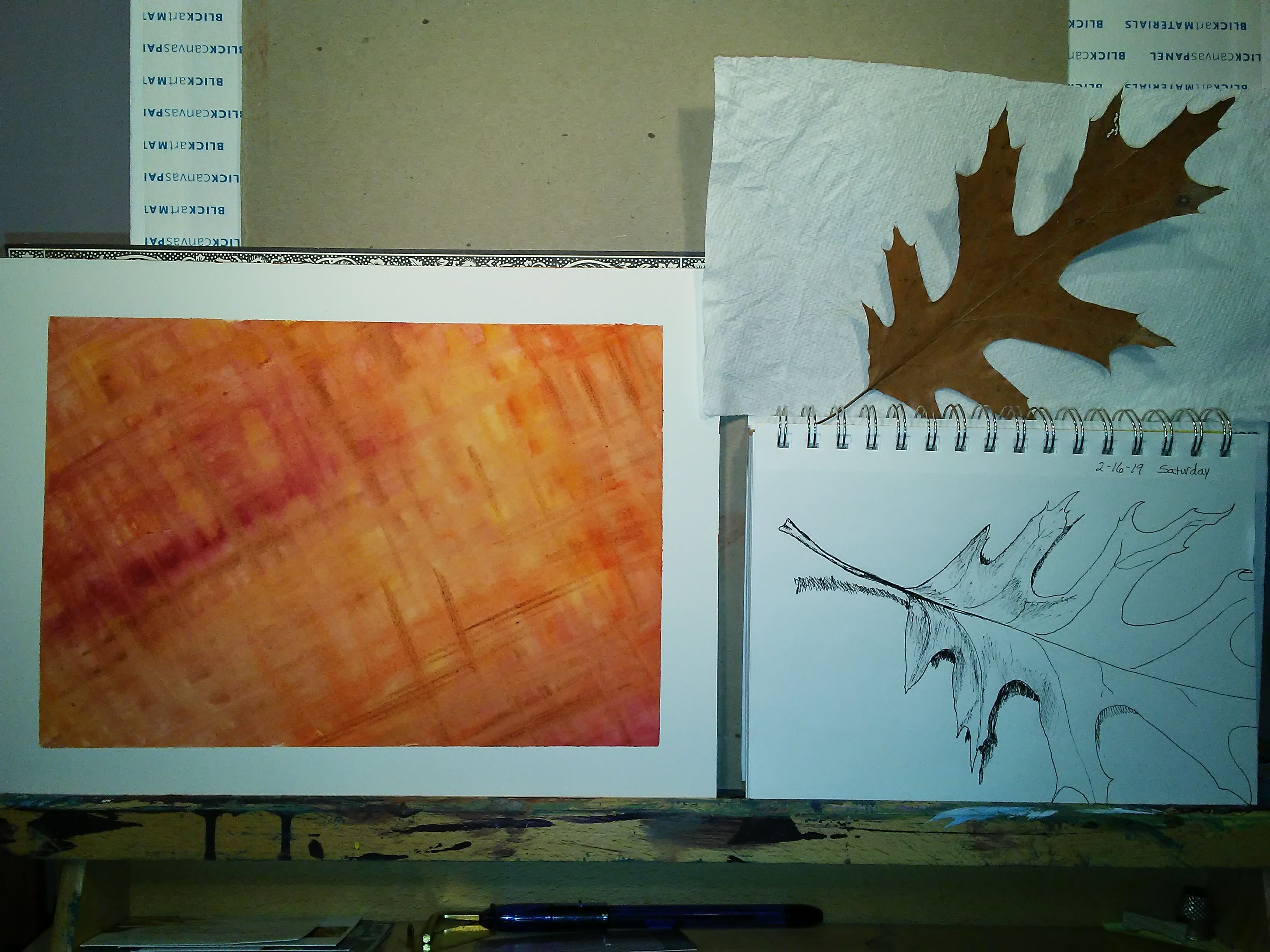 leaf, sketch, and orange painting on an easel