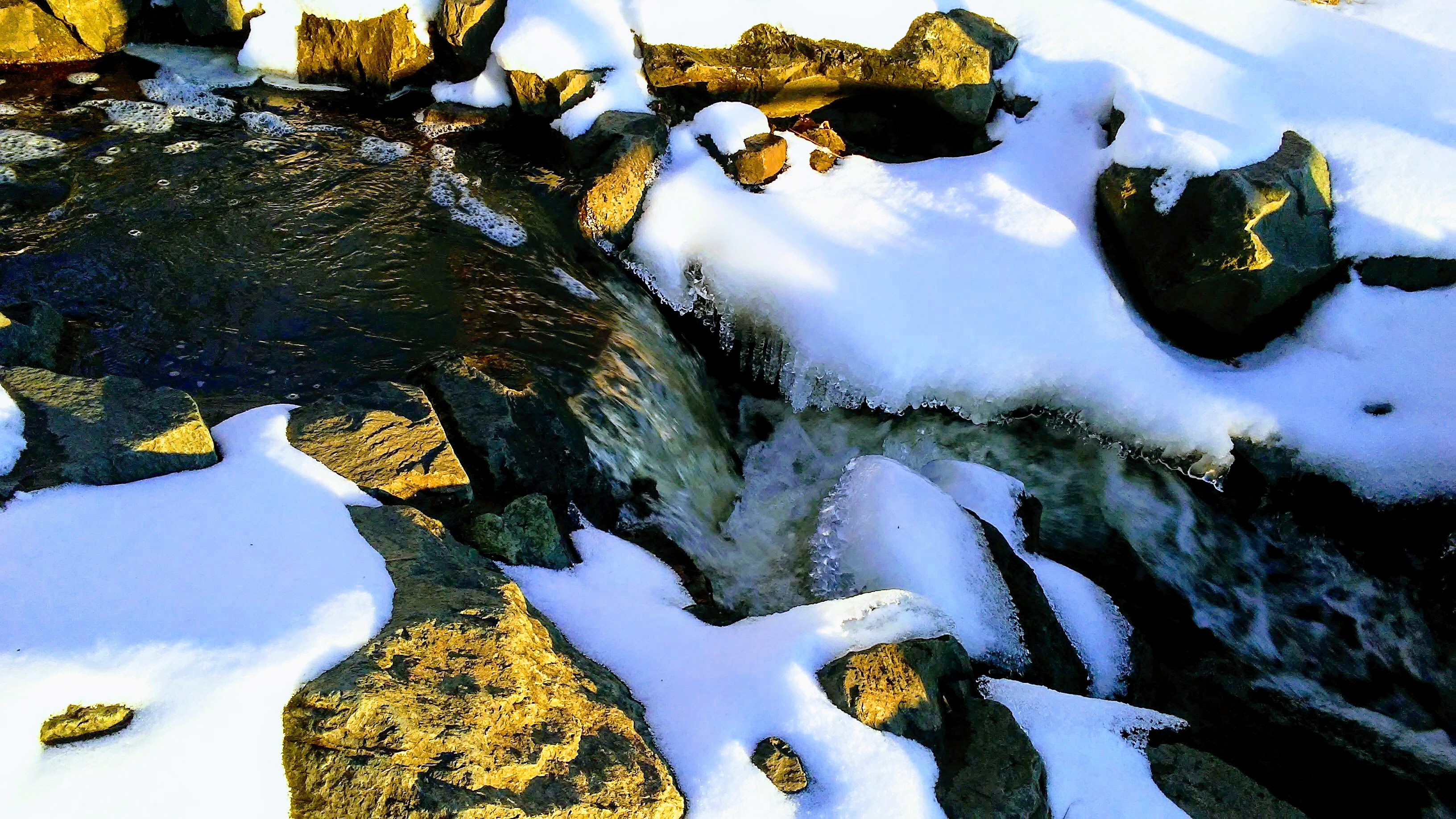 tan rocks, snow, water.