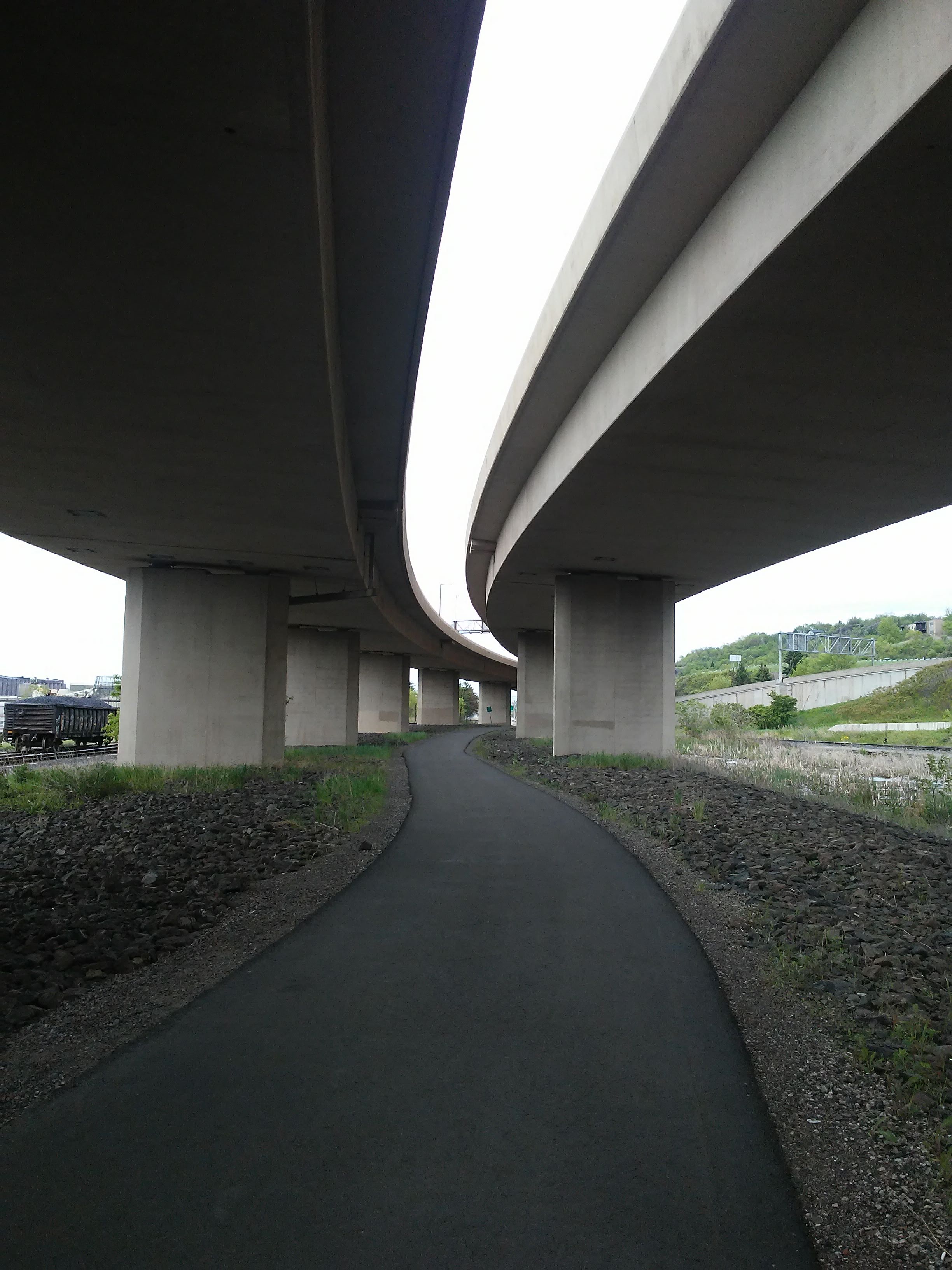 Paved trail under I-35 freeway.