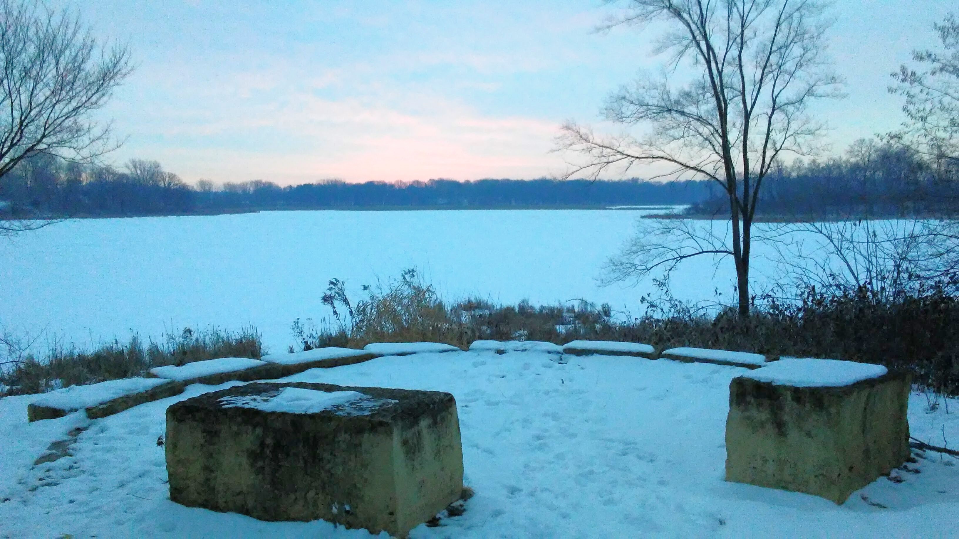 winter scene with lake and square stone seats