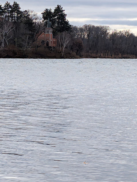 photo of lake with chapel on far shore