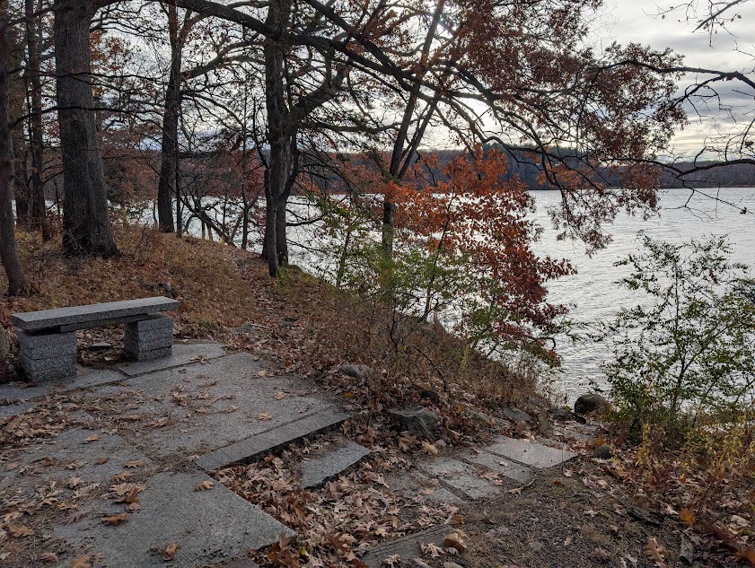 stone bench next to a lake